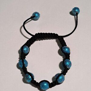 blue metal ball bracelet with black rope string